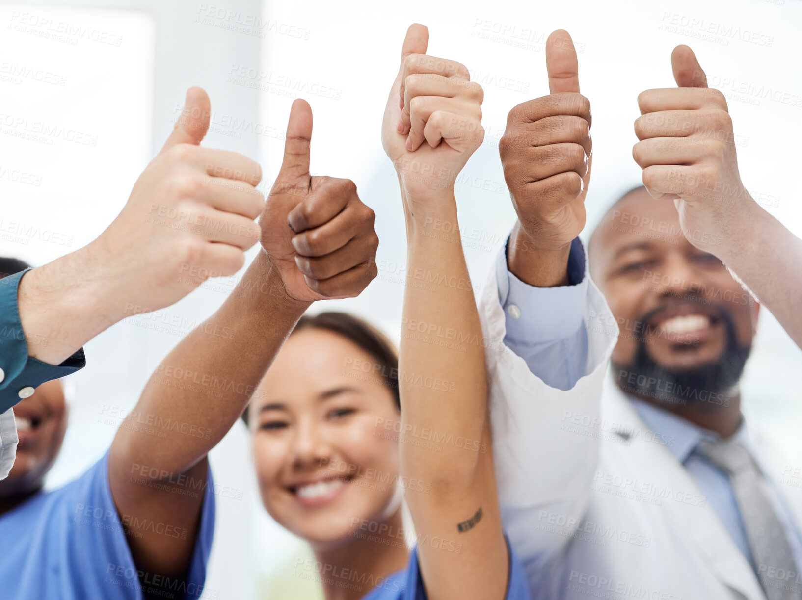 Buy stock photo Shot of a group of doctors showing a thumbs up in a office