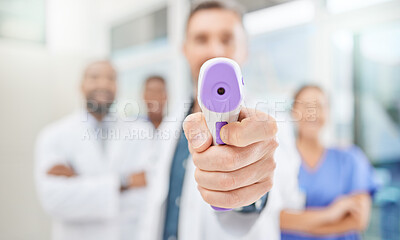Buy stock photo Shot of a doctor using an infrared thermometer during an outbreak