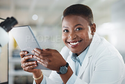 Buy stock photo Shot of a young scientist using a digital tablet while working in a lab