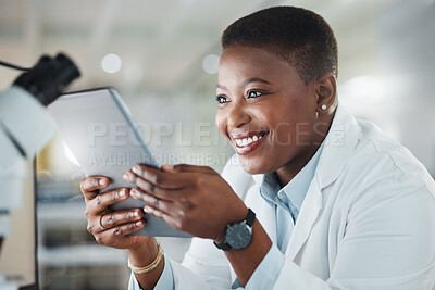 Buy stock photo Shot of a young scientist using a digital tablet while working in a lab