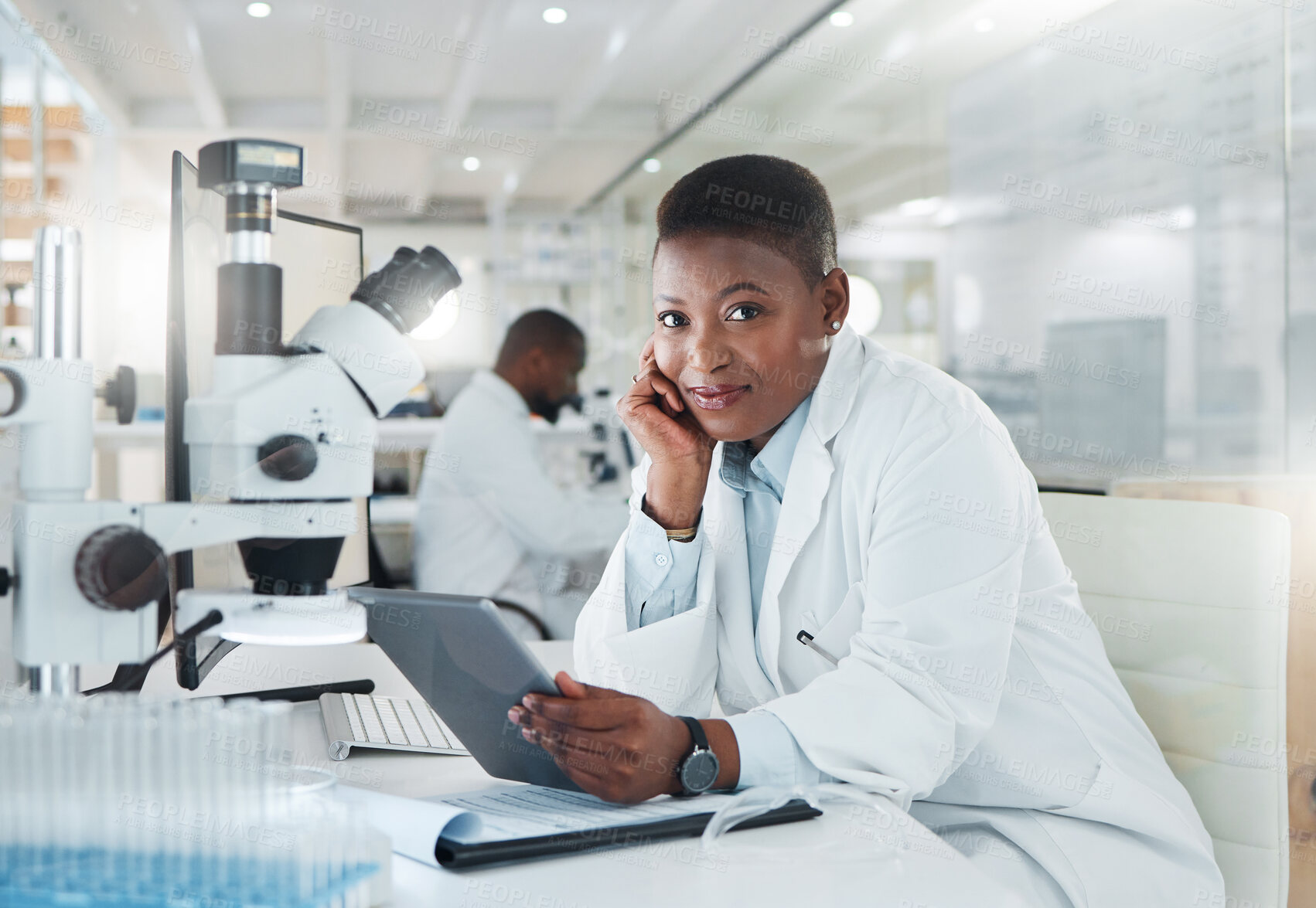 Buy stock photo Shot of a young scientist using a digital tablet while working in a lab