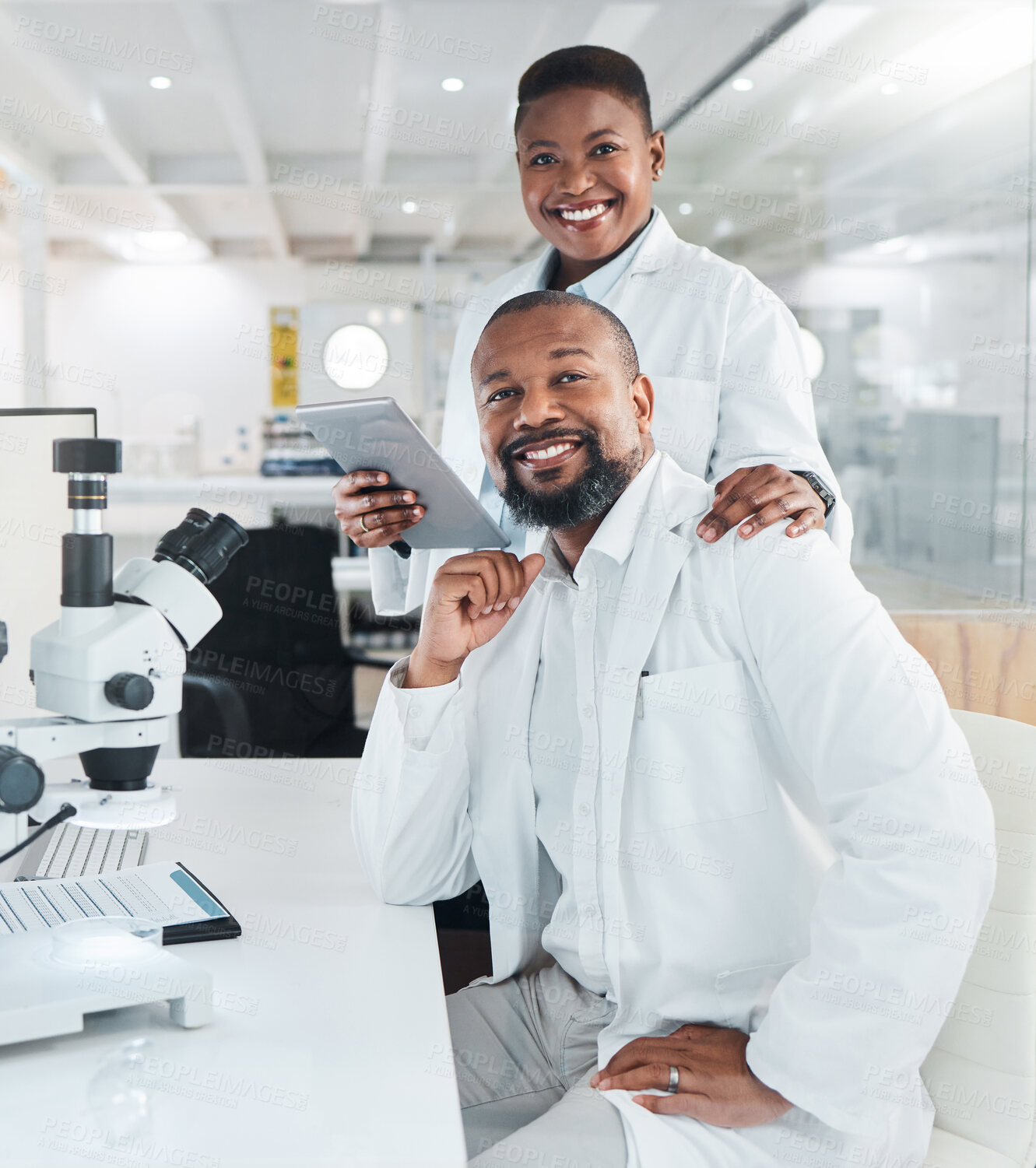 Buy stock photo Shot of two scientists using microscopes in a lab