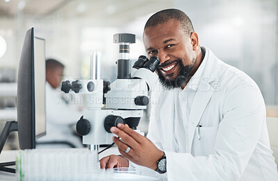 Buy stock photo Shot of a mature man using a microscope in a lab