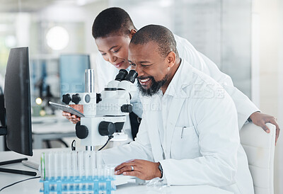 Buy stock photo Shot of two scientists using microscopes in a lab