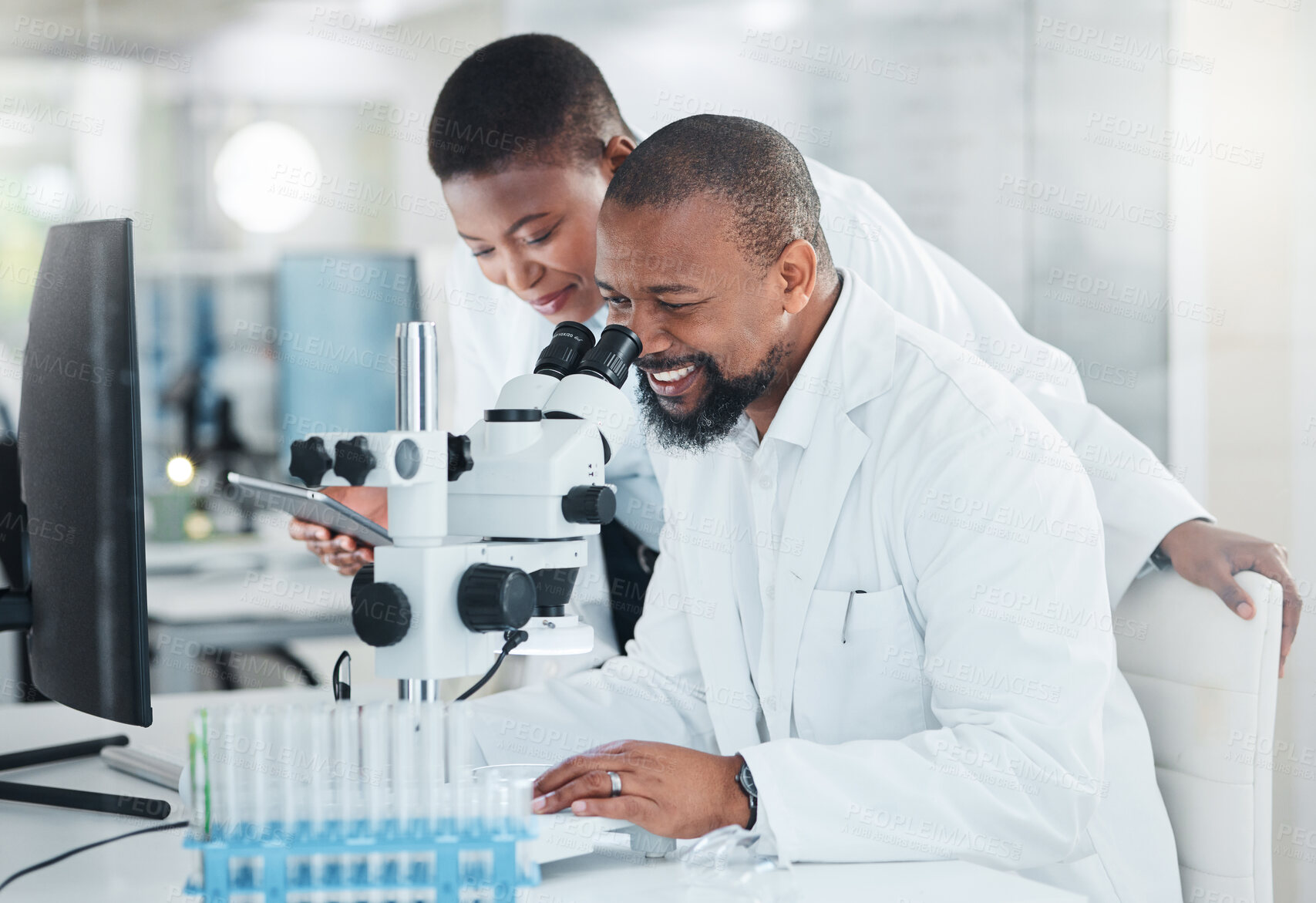 Buy stock photo Shot of two scientists using microscopes in a lab