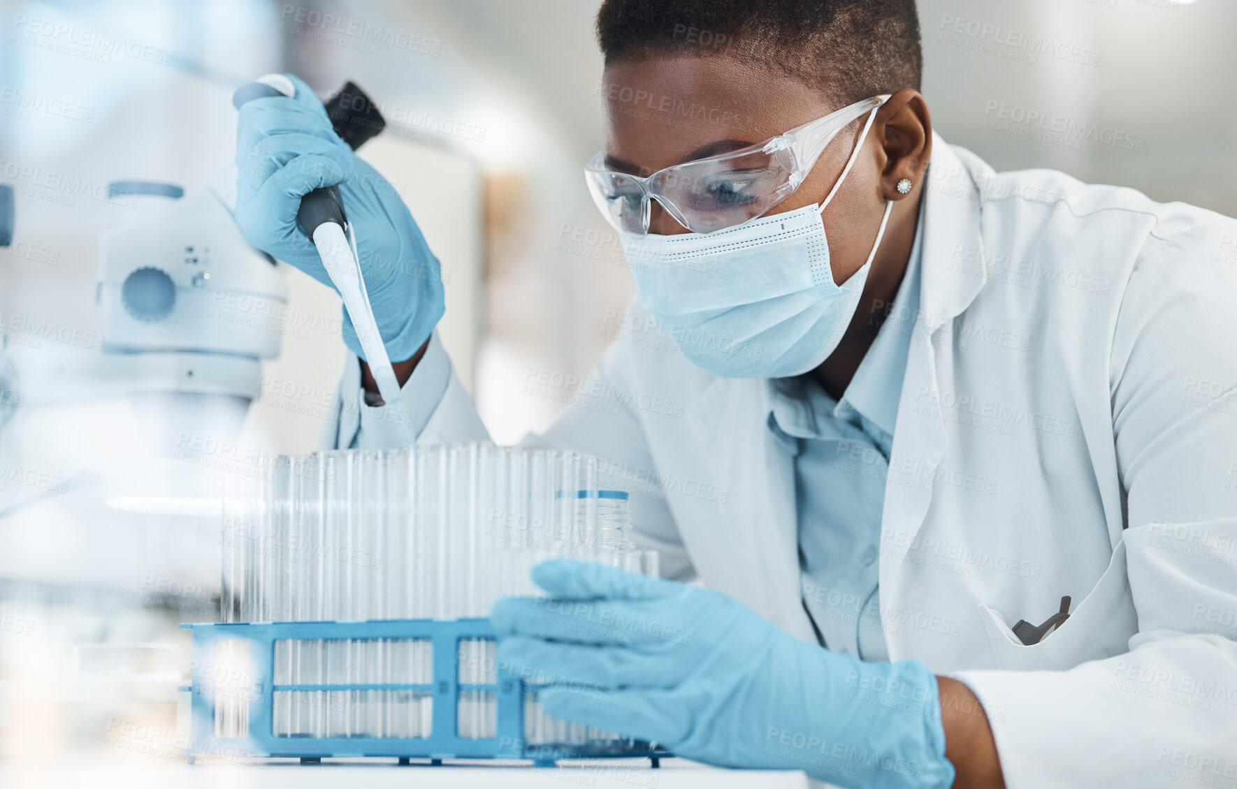 Buy stock photo Shot of a young scientist working with samples in a lab