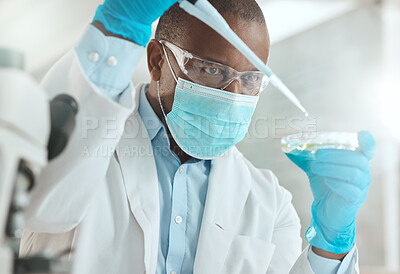 Buy stock photo Shot of a mature scientist sitting alone in his laboratory and testing urine