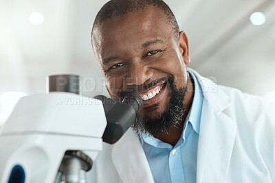 Buy stock photo Shot of a handsome mature scientist using a microscope to analyse a sample in the laboratory