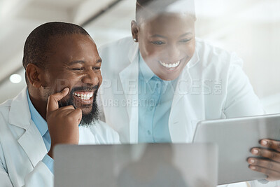 Buy stock photo Shot of two scientists using a laptop and digital tablet in a laboratory