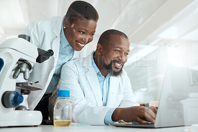 Buy stock photo Shot of two scientists using a laptop in a laboratory