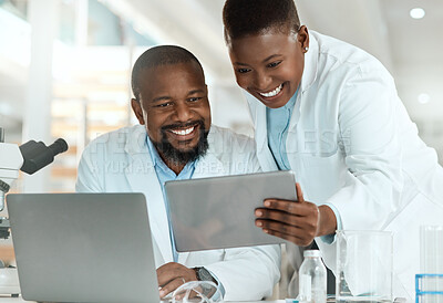 Buy stock photo Shot of two scientists using a laptop and digital tablet in a laboratory