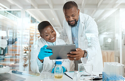 Buy stock photo Shot of two scientists using a digital tablet in a laboratory