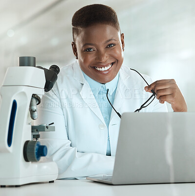 Buy stock photo Shot of an attractive young scientist sitting alone in her laboratory and using her laptop