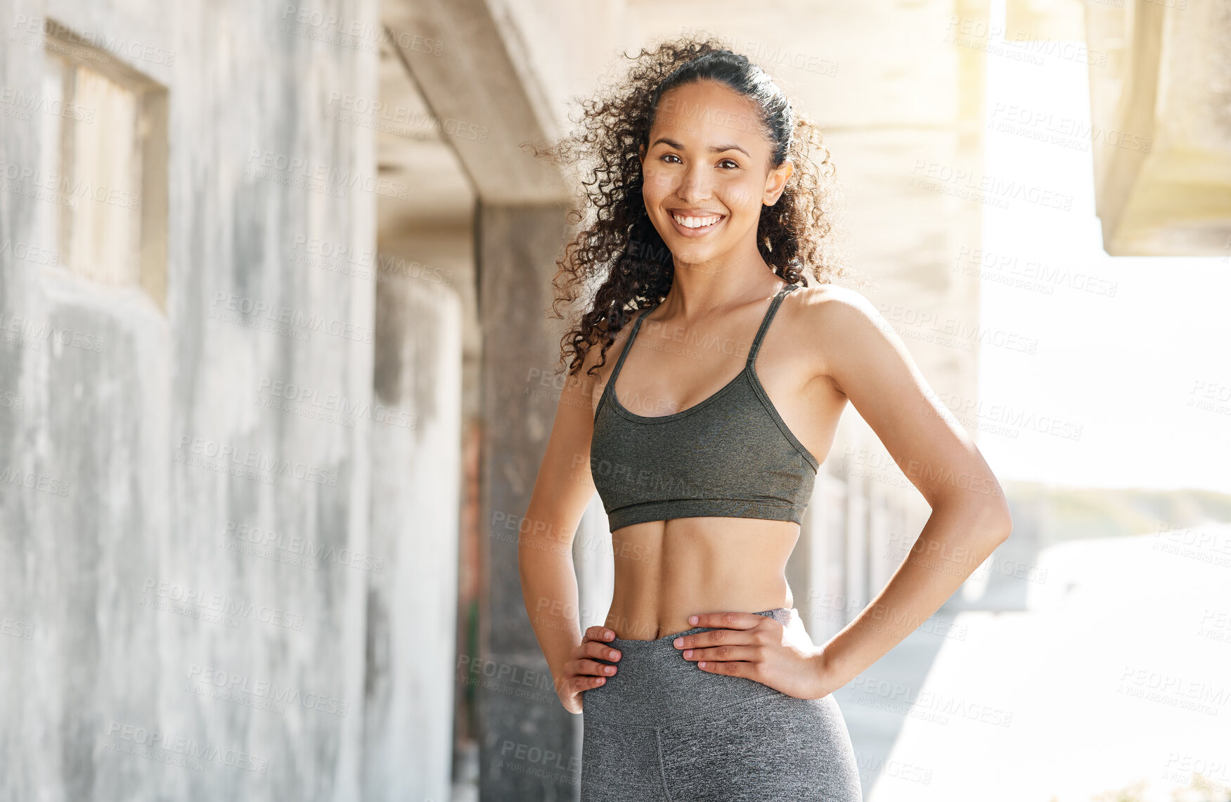 Buy stock photo Shot of an attractive young woman standing alone in the city during her outdoor workout