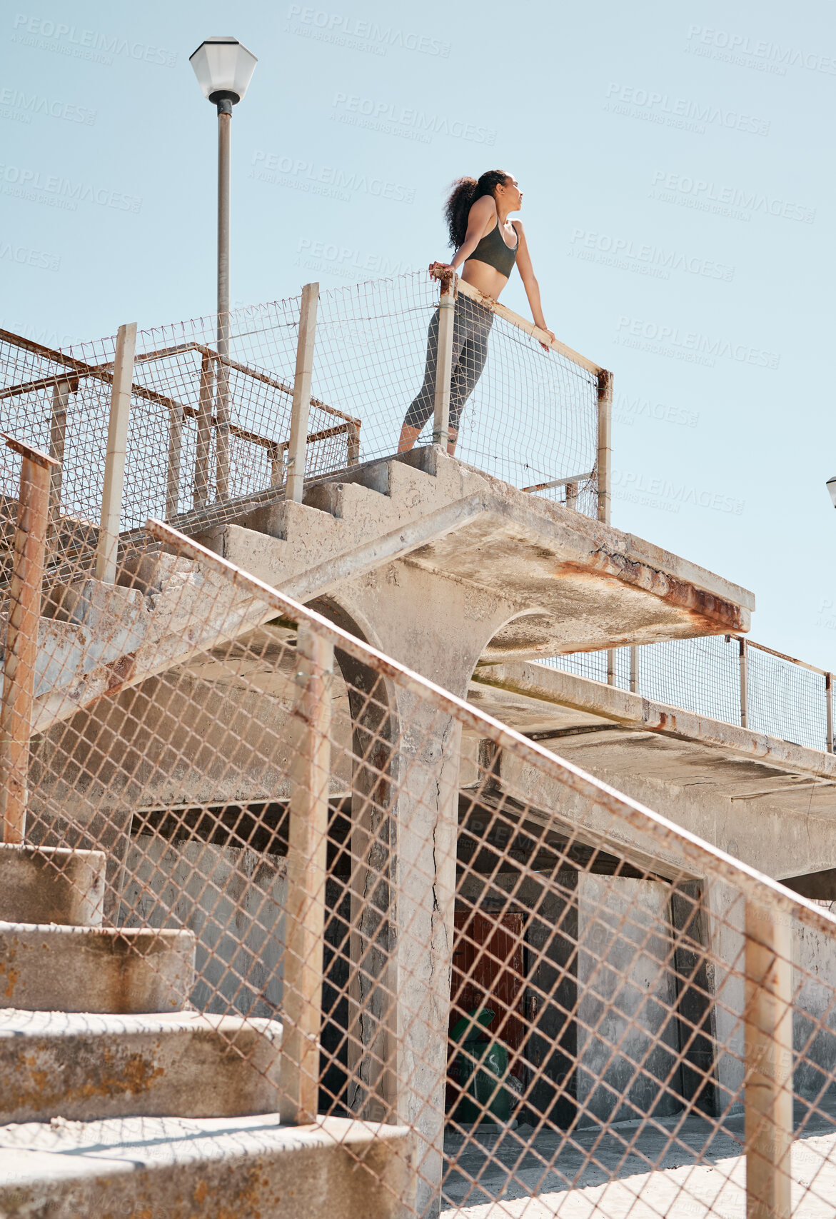 Buy stock photo Shot of a young woman standing alone in the city during her outdoor workout