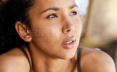 Buy stock photo Shot of an attractive young woman taking a moment to catch her breath during her outdoor workout