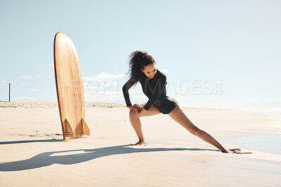 Buy stock photo Shot of a young woman stretching on the beach