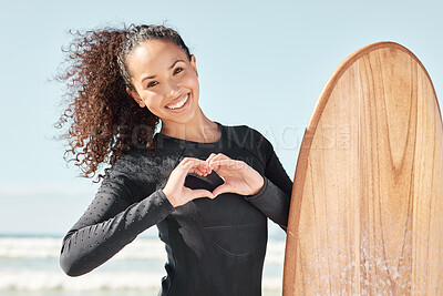 Buy stock photo Shot an attractive young woman posing with her surfboard and going out to surf at the beach