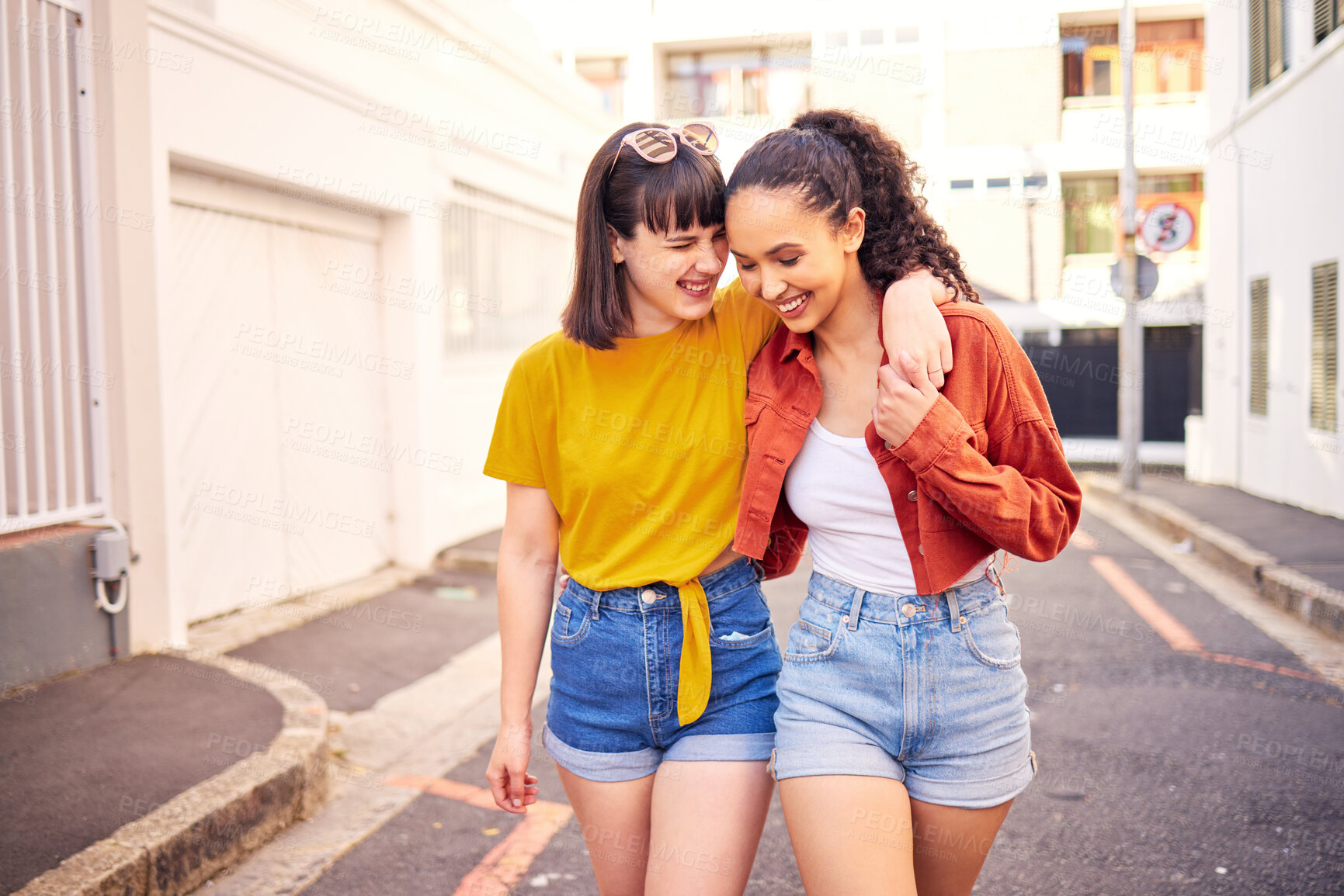 Buy stock photo Happy, love and lesbian couple walking in the city for sightseeing, exploring and adventure. Smile, romance and young interracial lgbtq women bonding for travel together in urban town street or road.