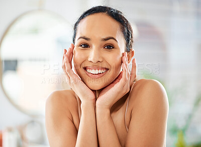 Buy stock photo Shot of a young woman admiring her skin in a bathroom at home