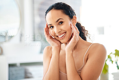 Buy stock photo Shot of a young woman admiring her skin in a bathroom at home