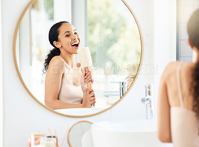 Buy stock photo Shot of a young woman singing in a bathroom at home