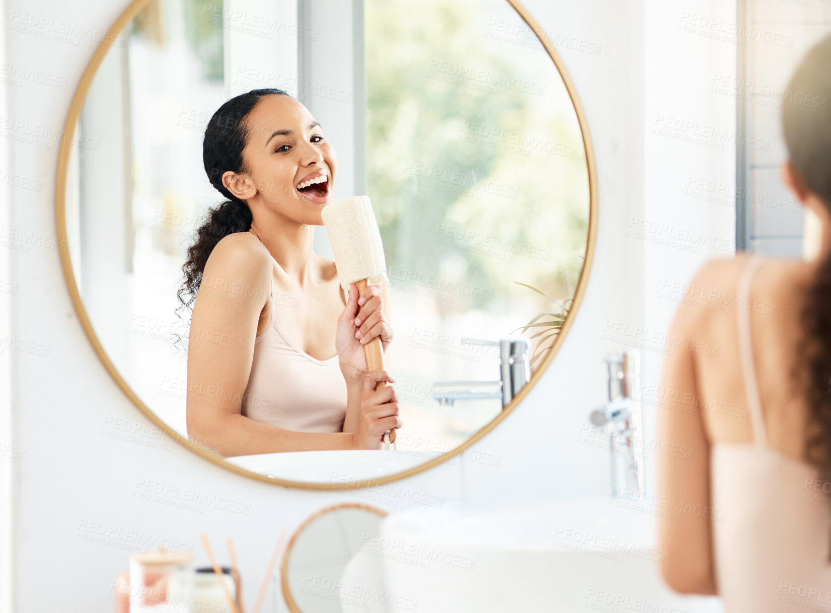 Buy stock photo Shot of a young woman singing in a bathroom at home