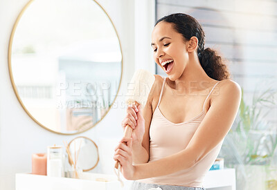 Buy stock photo Shot of a young woman singing in a bathroom at home