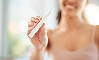 Buy stock photo Shot of an unrecognizable woman holding feminine hygiene products in a bathroom at home