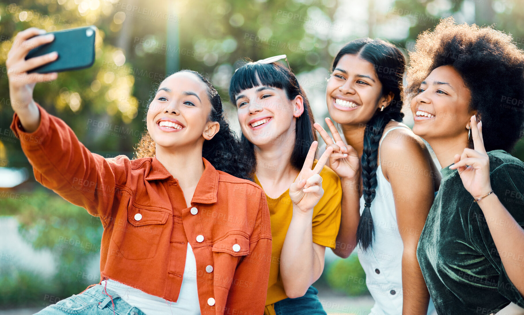 Buy stock photo Shot of a group of friends taking a selfie in a park