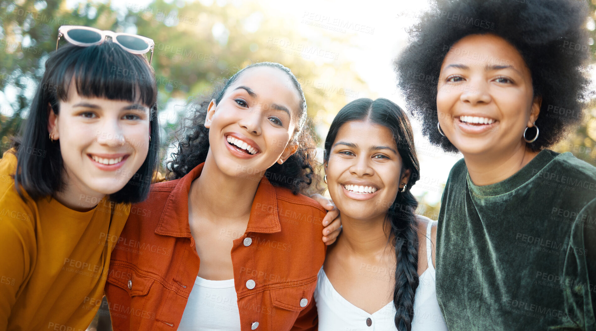 Buy stock photo Shot of a group of female friends spending time together at a park