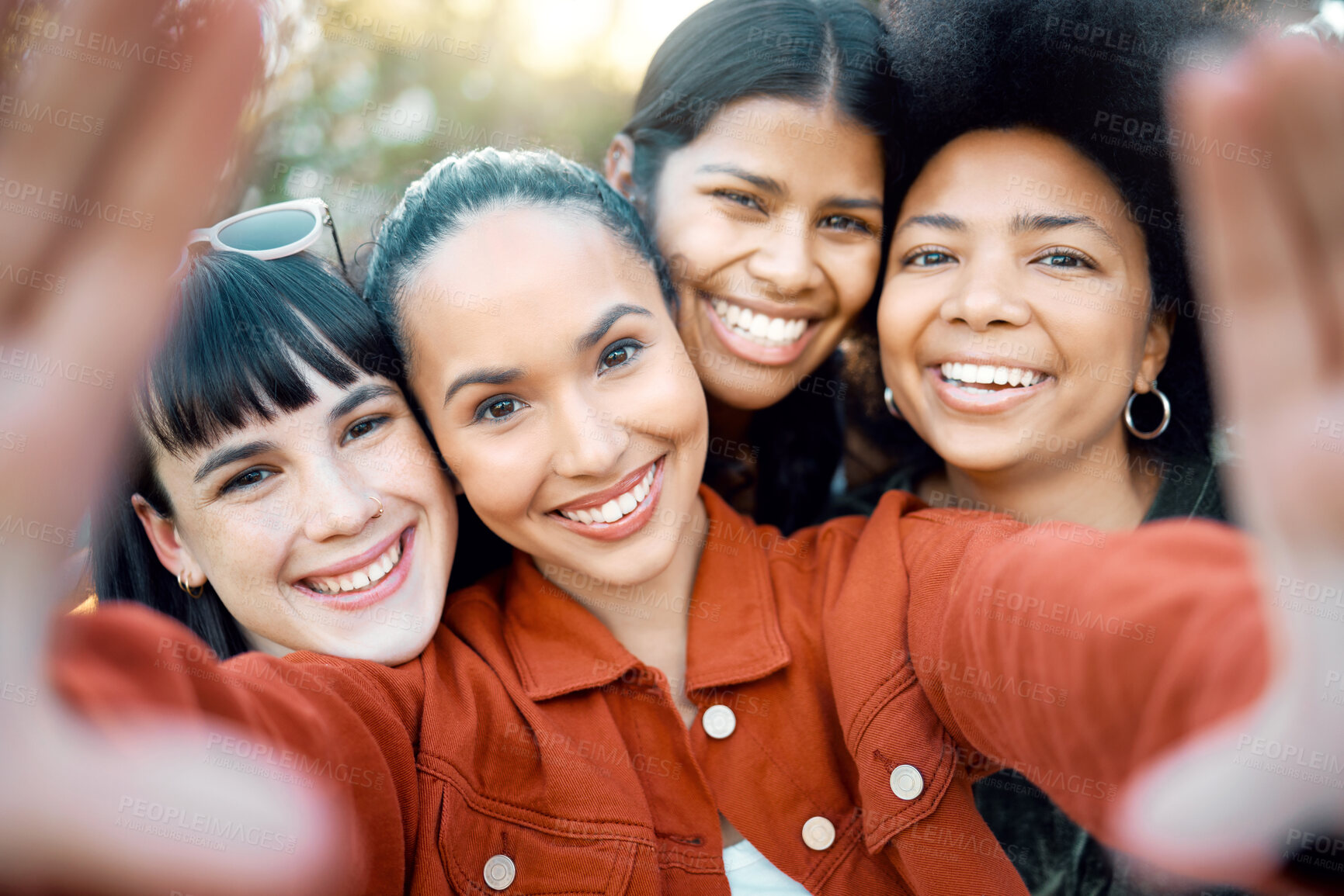 Buy stock photo Shot of a group of female friends taking a selfie in a park