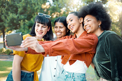 Buy stock photo Shot of a group of female friends taking a selfie in a park