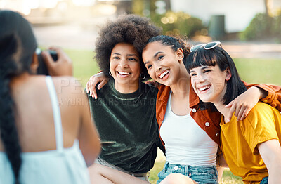 Buy stock photo Shot of a female taking photos of her friends in a park