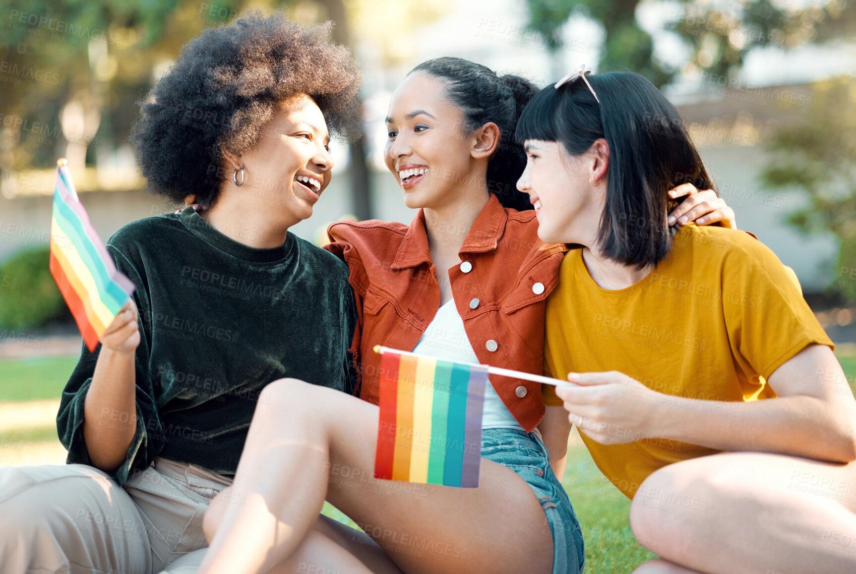 Buy stock photo Shot of a group of friends sitting in a park