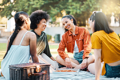 Buy stock photo Shot of a group of friends sitting in a park