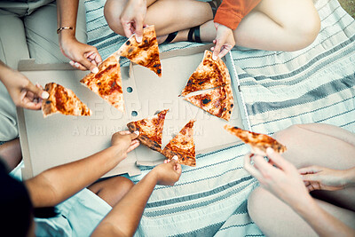 Buy stock photo Shot of an unrecognizable friends sharing pizza outside