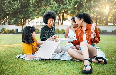 Buy stock photo Shot of a group of friends having champagne and pizza in a park