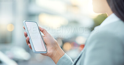 Buy stock photo Shot of a businesswoman using a smartphone against an urban background