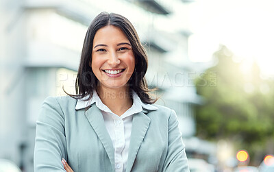 Buy stock photo Portrait of a confident young businesswoman standing against an urban background