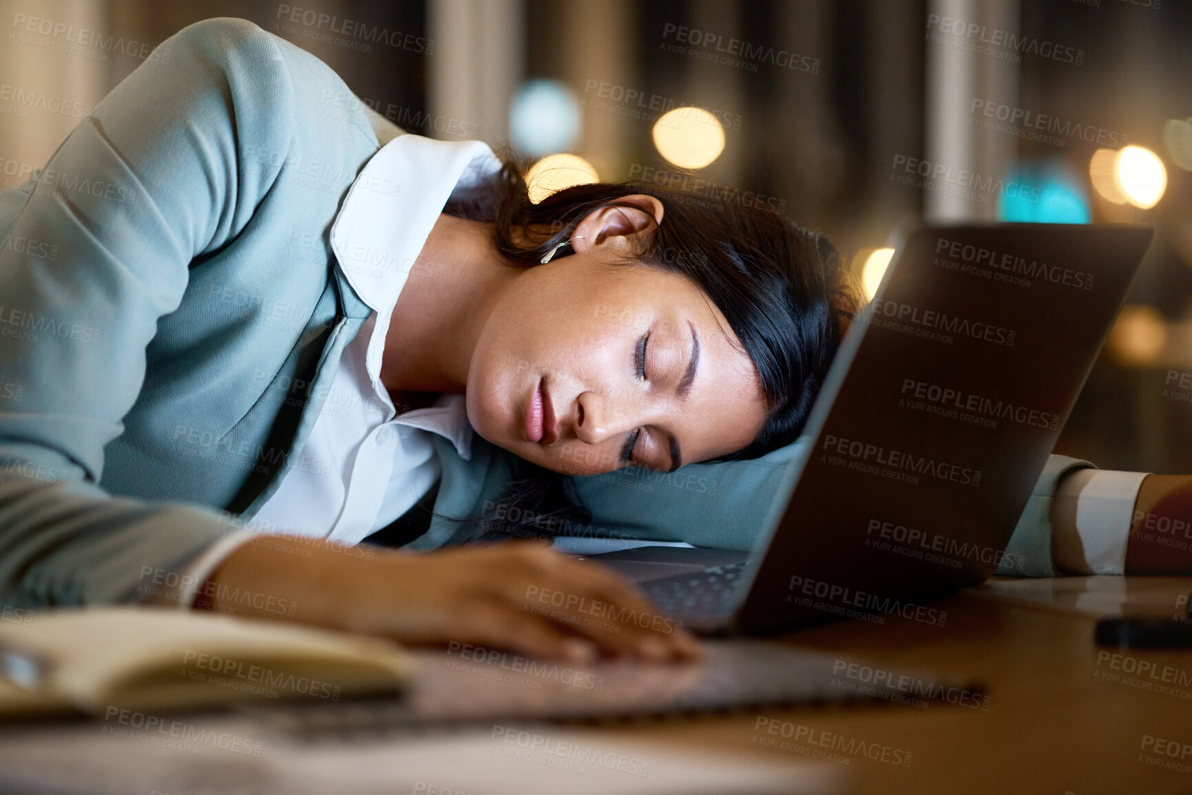 Buy stock photo Cropped shot of an attractive young businesswoman sleeping on her desk while working late at the company offices