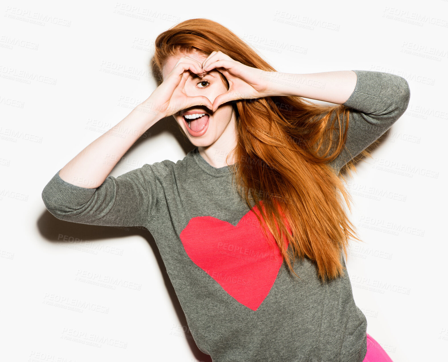 Buy stock photo Heart hands, energy and portrait of excited woman in studio isolated on white background for love. Eye, frame and vision with happy person in valentines day jersey for celebration of romance