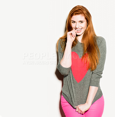 Buy stock photo Smile, girl and portrait in studio for fashion with heart on sweatshirt for symbol of love on valentines day. Female person, mockup space and white background with trendy outfit for chic casual look.