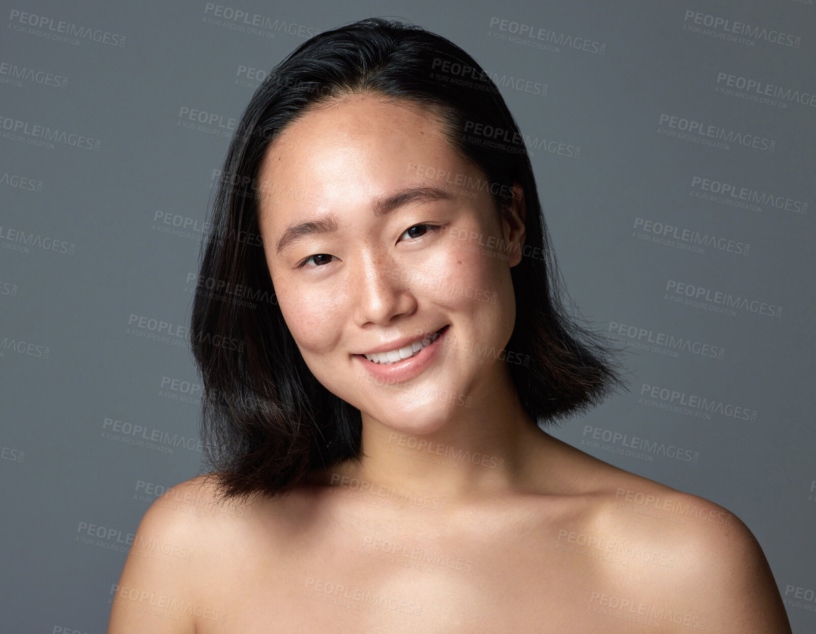 Buy stock photo Studio shot of a beautiful young woman posing against a grey background