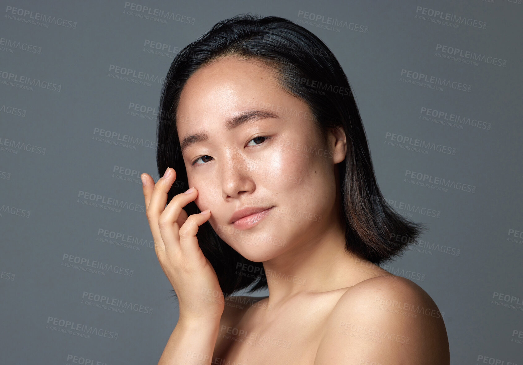 Buy stock photo Studio shot of a beautiful young woman posing against a grey background