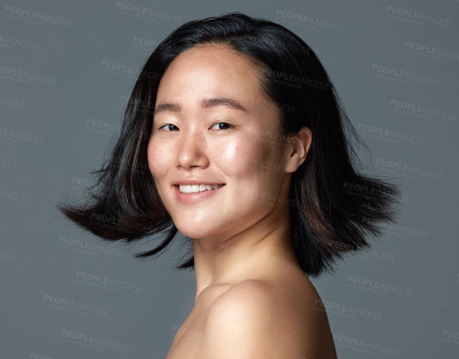 Buy stock photo Studio shot of a beautiful young woman posing against a grey background