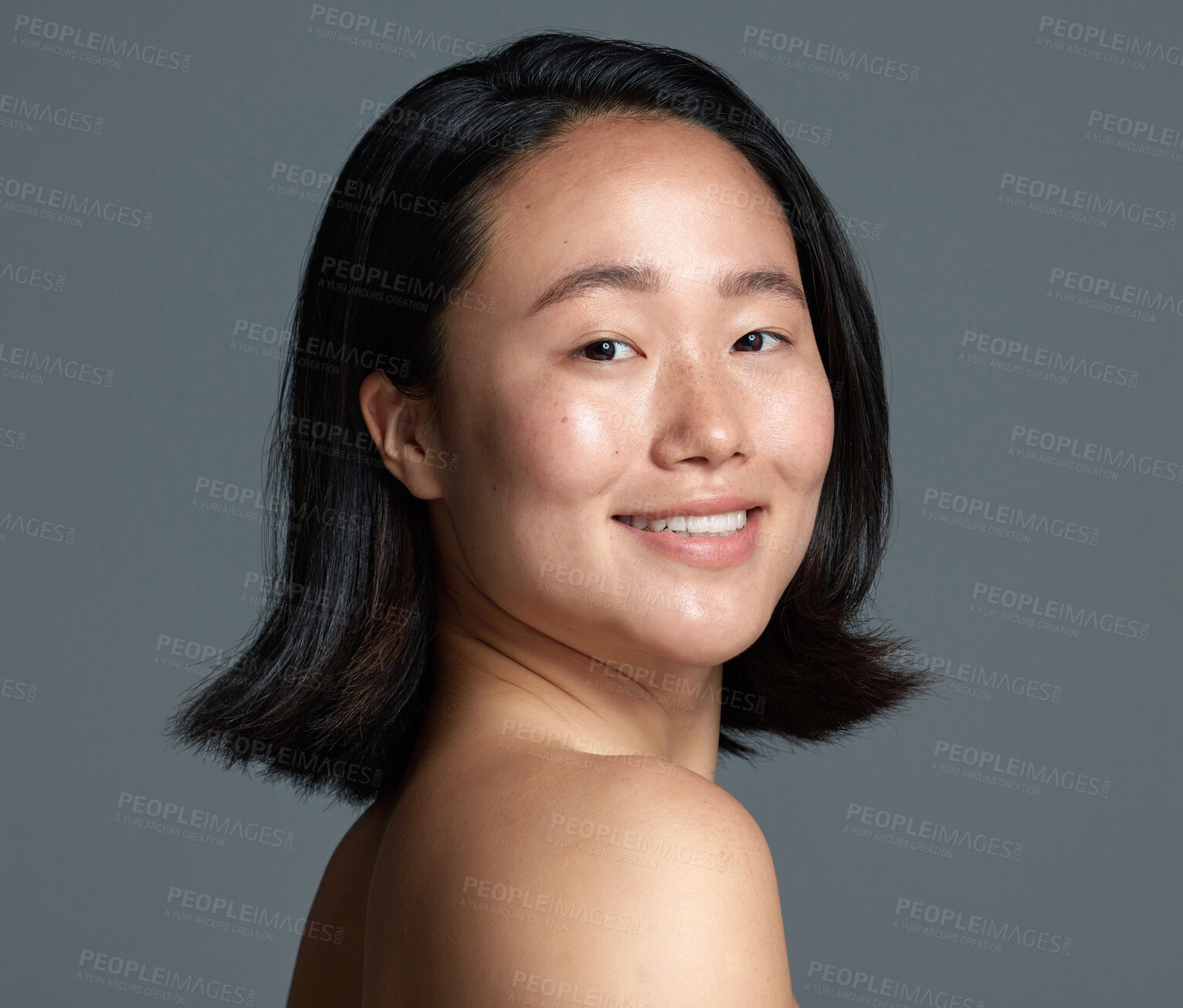 Buy stock photo Studio shot of a beautiful young woman posing against a grey background