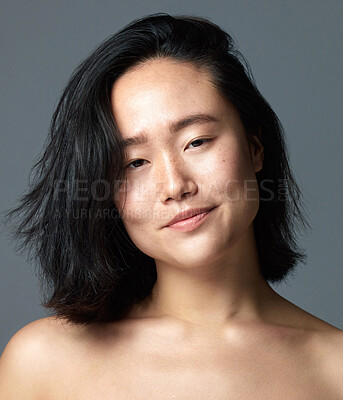 Buy stock photo Studio shot of a beautiful young woman posing against a grey background