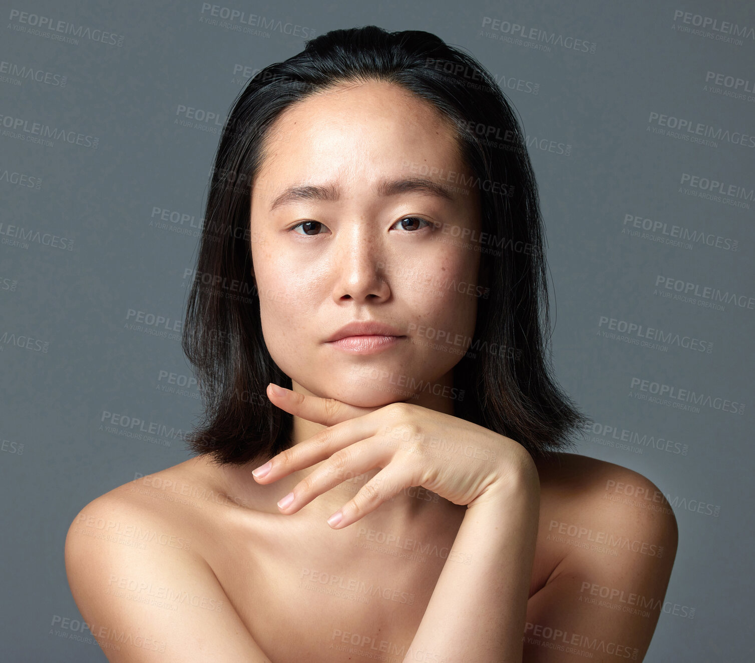 Buy stock photo Studio shot of a beautiful young woman posing against a grey background