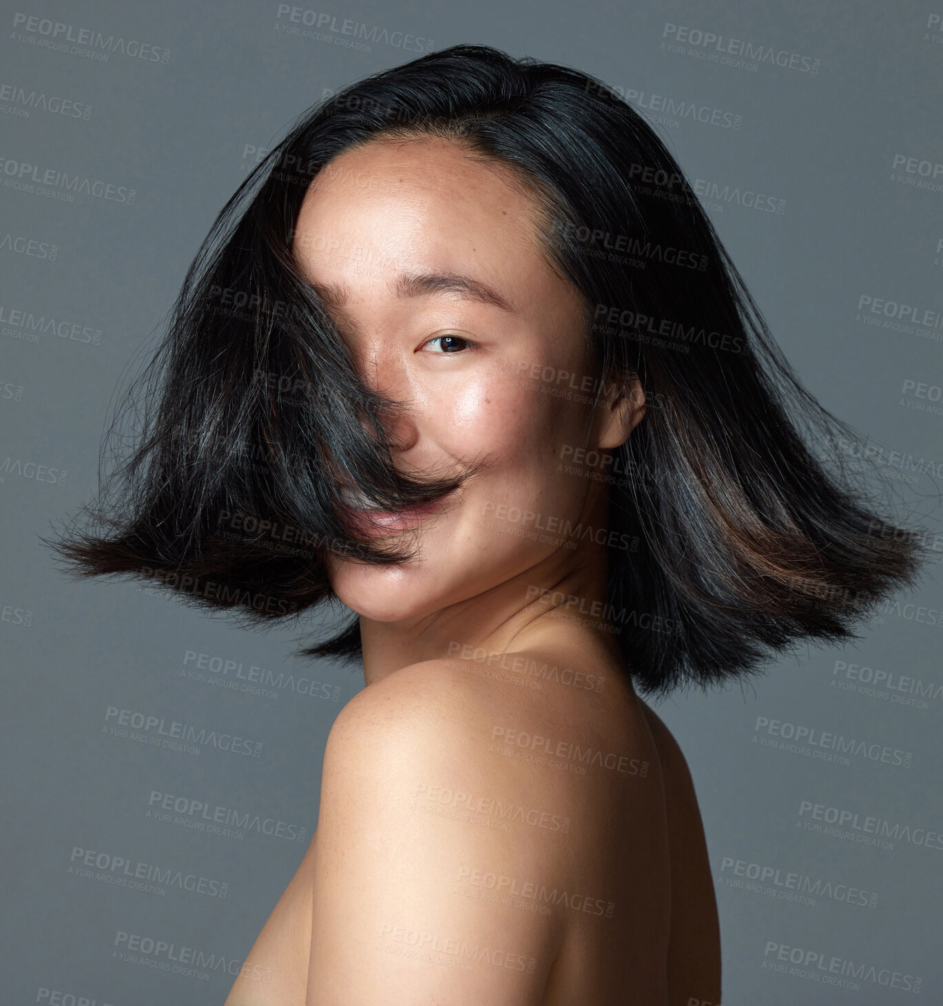 Buy stock photo Asian woman, portrait and shake hair in studio with bob hairstyle, self care and bounce. Female person, shampoo and haircare on gray background for healthy texture, shine or beauty with collagen